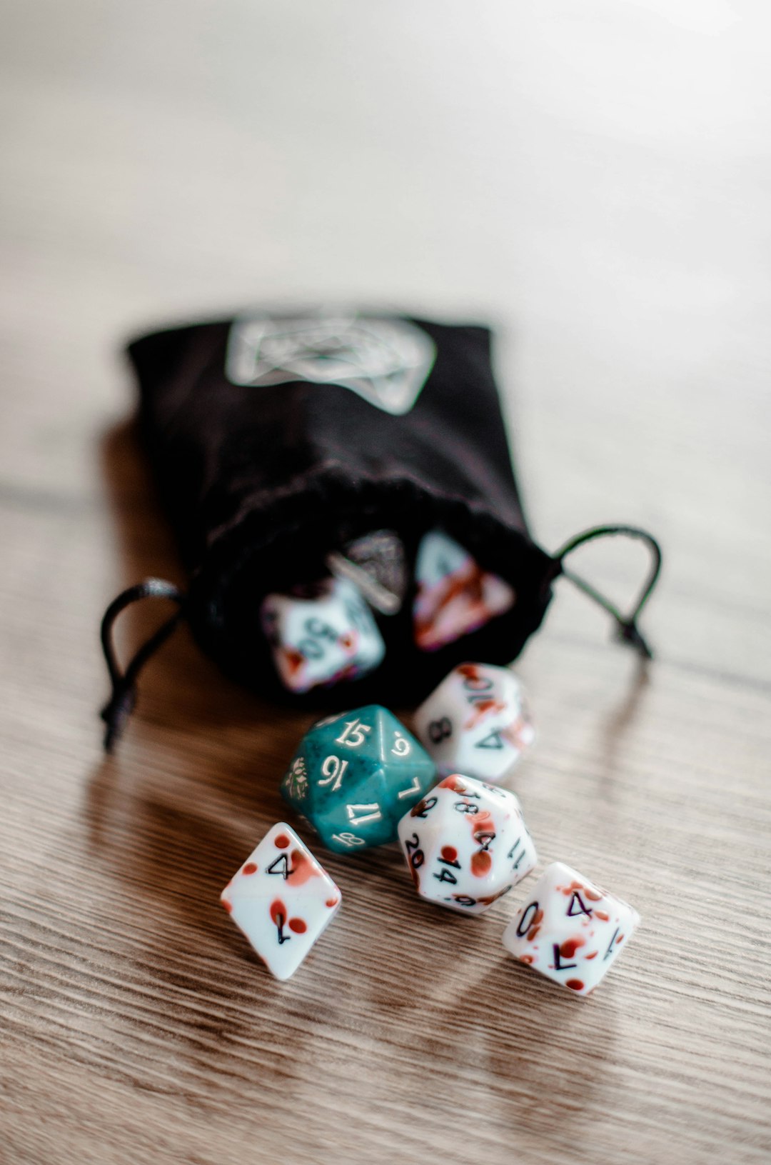 who-we-are a-bag-filled-with-dice-sitting-on-top-of-a-wooden-table-tmzftjxtorc
