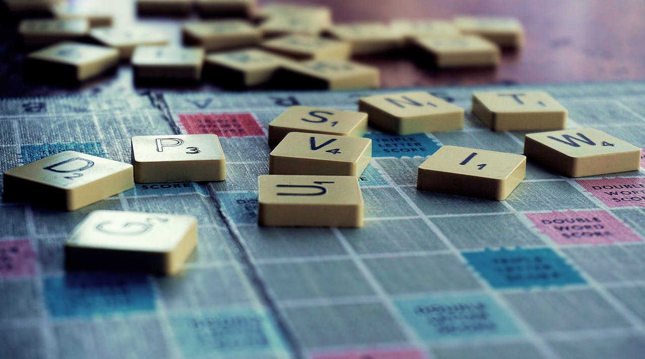 about-us Close-up of Scrabble tiles scattered on the board, capturing leisure and word play.